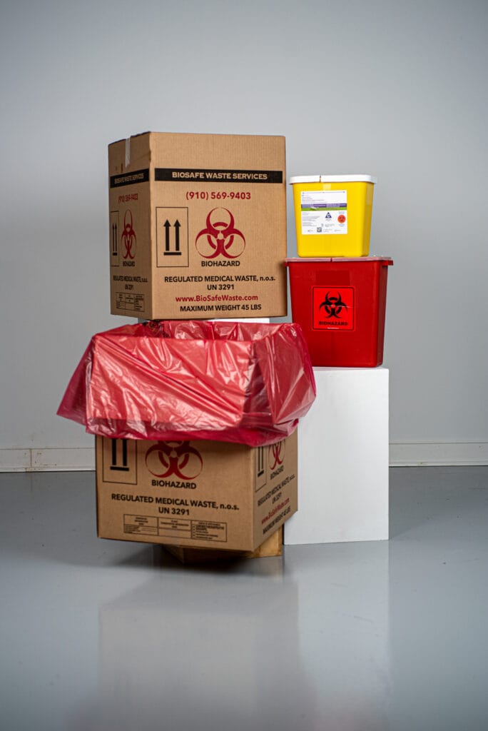 Regulated medical waste boxes and sharps containers staged for pickup