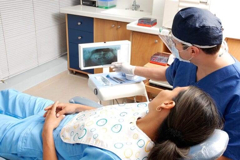Dentist reviewing a dental X-ray with a patient in the exam chair
