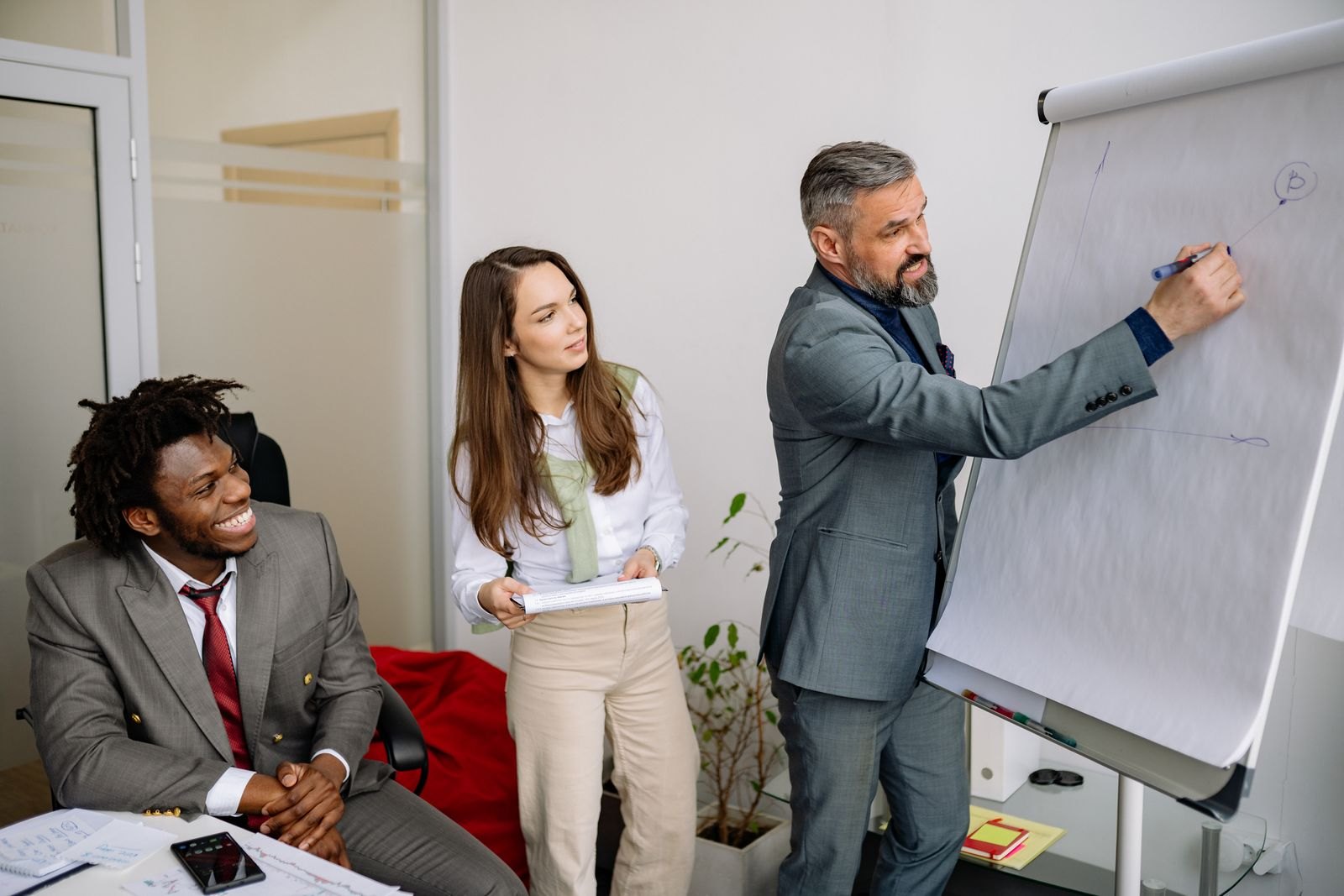 Instructor leading a compliance training session for a team of professionals