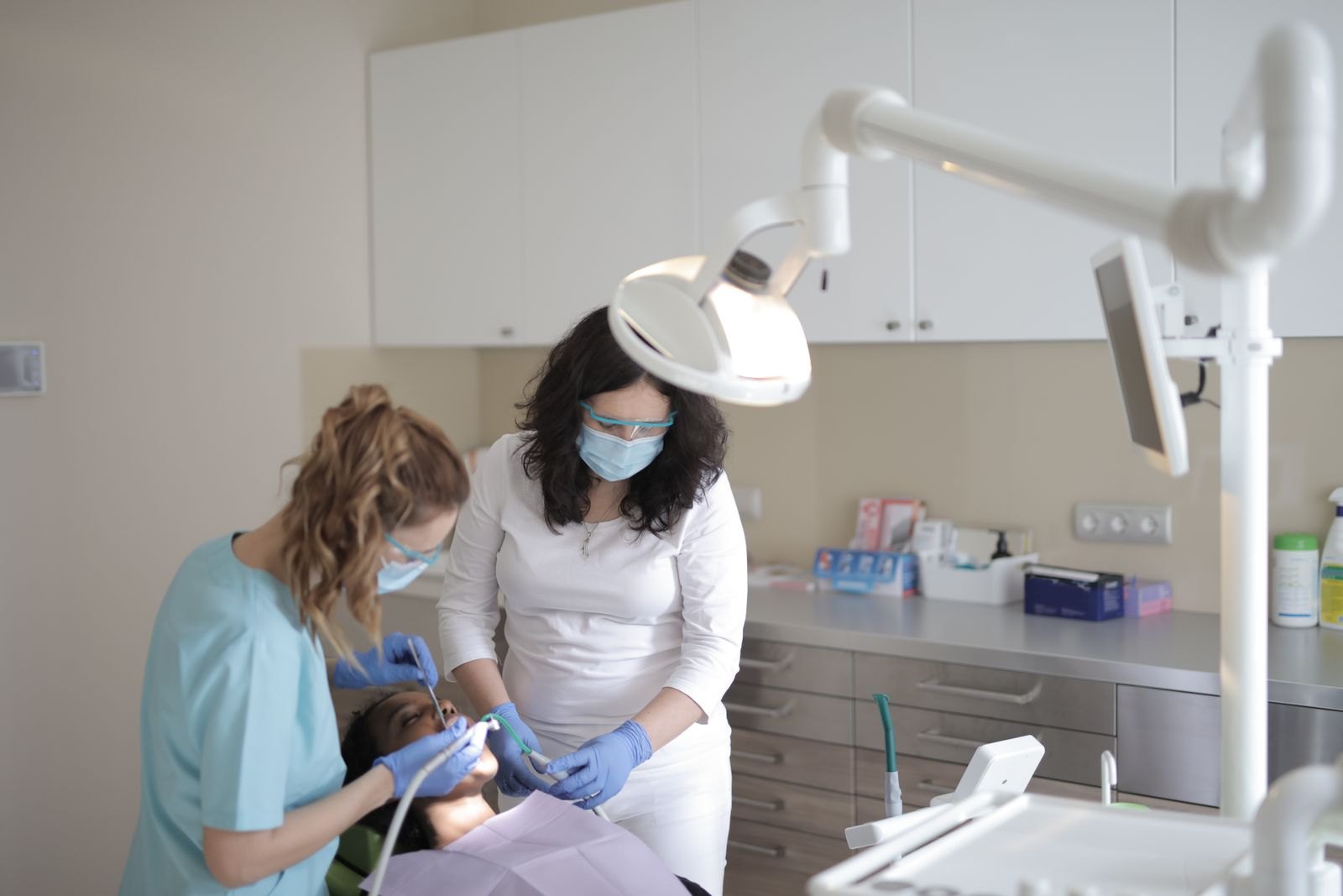 Dental team treating a patient in a modern dental operatory